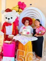 Mesa decorada con torta y cartel de cumpleaños